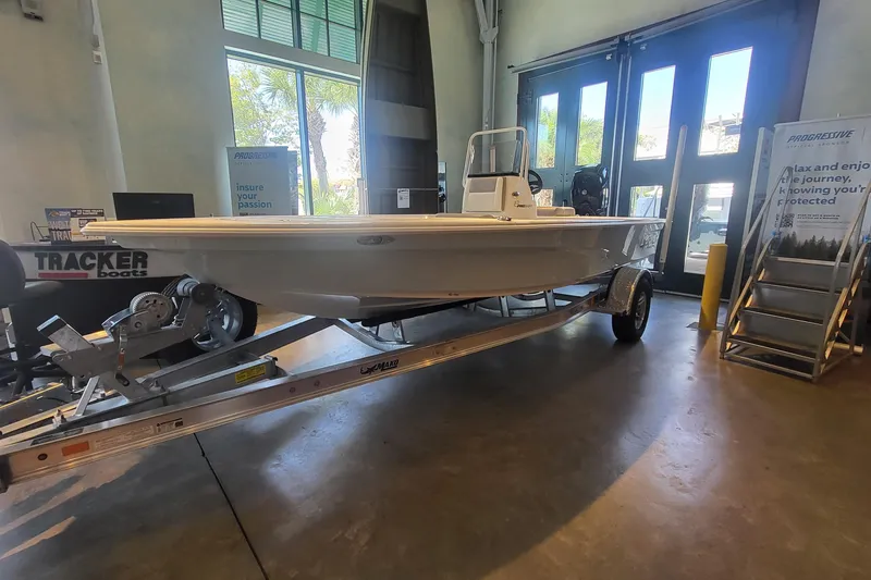 Slide: The Image of 2026 Mako Pro Skiff 18 boat displayed indoors on a trailer. - 6