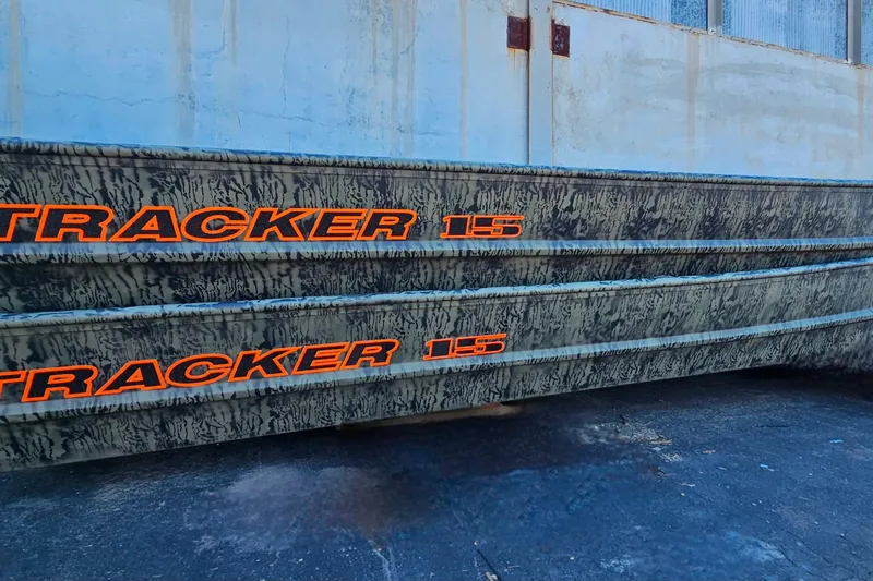 The Image of 2026 Tracker Grizzly 15 Jon boat on trailer in parking lot. - 0