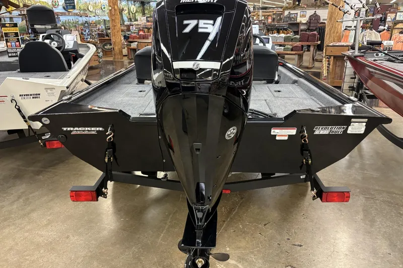 Slide: The Image of 2026 Tracker Pro Team 175 Crappie Edition boat with Mercury 75 engine, displayed indoors. - 2