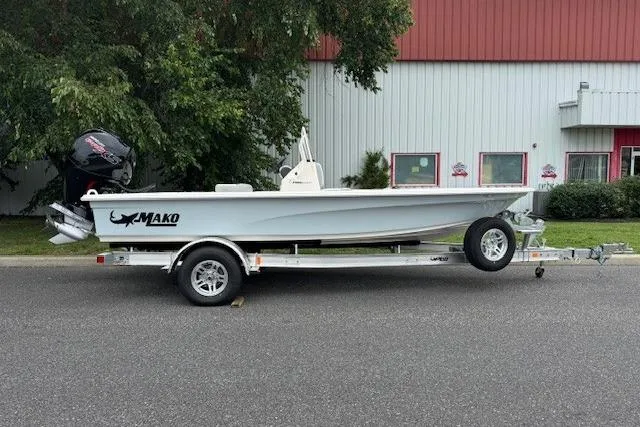 The Image of 2026 Mako 18 Pro Skiff boat on trailer, parked outdoors near a building. - 0