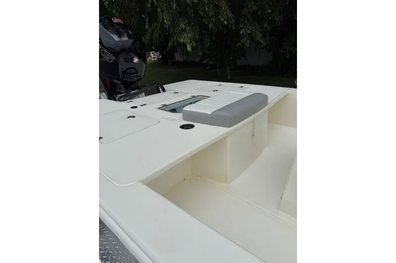 Slide: The Image of 2026 Mako 18 Pro Skiff boat interior with motor, featuring spacious deck design. - 10