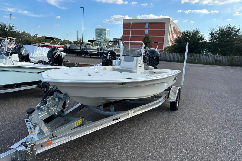 The Image of 2026 Mako 18 Pro Skiff boat on trailer in parking lot. - 0