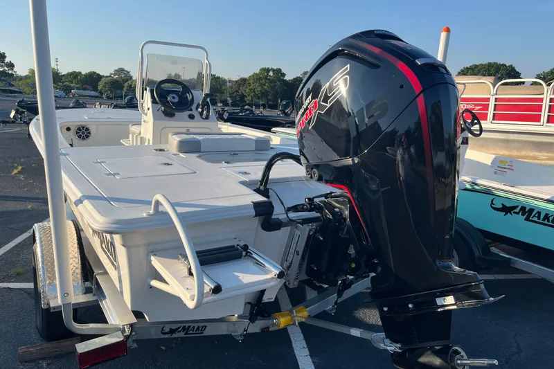 Slide: The Image of 2026 Mako 18 Pro Skiff boat with powerful outboard motor in a parking lot. - 3