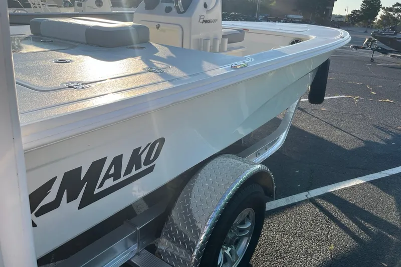 Slide: The Image of 2026 Mako 18 Pro Skiff boat on trailer in parking lot. - 7