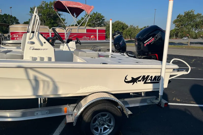 Slide: The Image of 2026 Mako 18 Pro Skiff boat on trailer, featuring Mercury outboard motor. - 4
