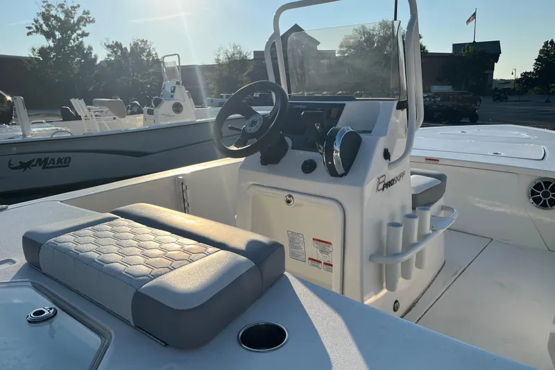 Slide: The Image of 2026 Mako 18 Pro Skiff boat interior with steering console and seating. - 6