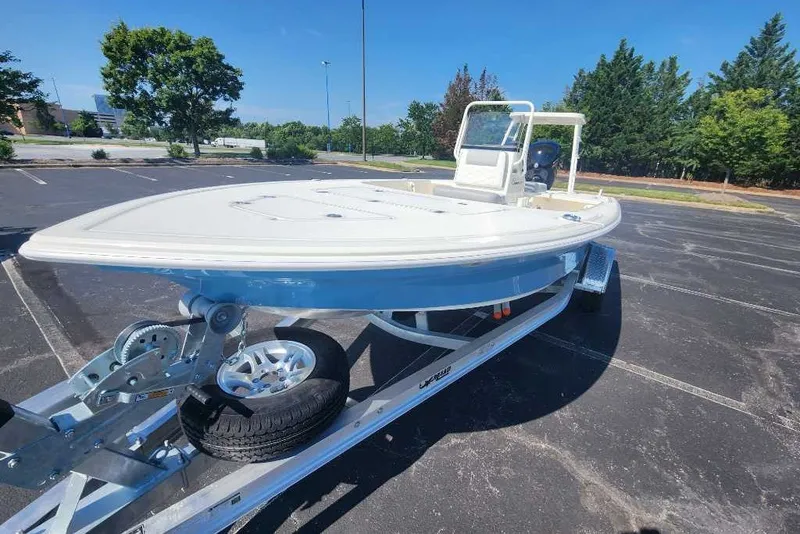 Slide: The Image of 2026 Mako 18 Pro Skiff boat on trailer in parking lot. - 60
