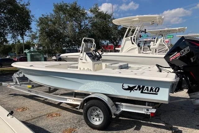 The Image of 2026 Mako 18 Pro Skiff boat on trailer, parked outdoors under clear sky. - 0