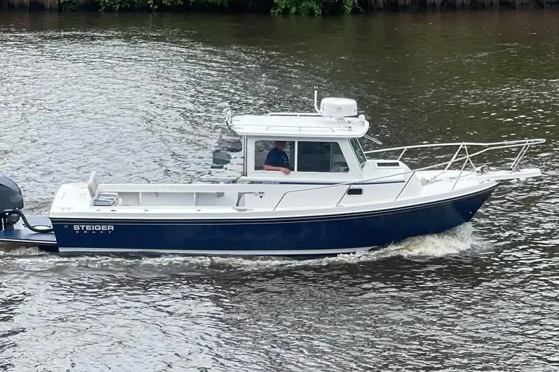 Slide: The Image of 2021 Steiger Craft 255 Chesapeake boat cruising on a river. - 1