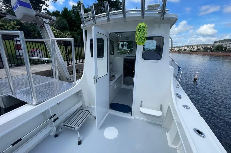 Slide: The Image of 2021 Steiger Craft 255 Chesapeake boat docked by a scenic waterfront. - 12