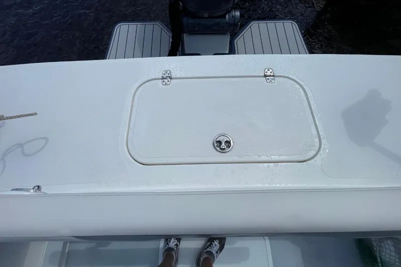 Slide: The Image of 2021 Steiger Craft 255 Chesapeake boat deck with storage hatch and motor. - 16