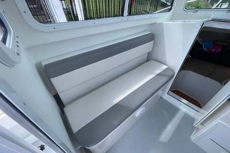 Slide: The Image of 2021 Steiger Craft 255 Chesapeake interior with gray and white seating. - 19