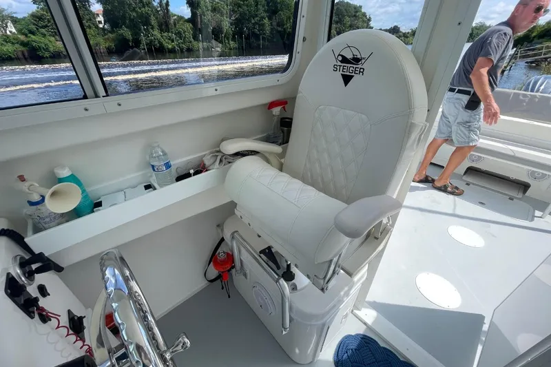 Slide: The Image of 2021 Steiger Craft 255 Chesapeake boat interior with steering wheel and captain's chair. - 26