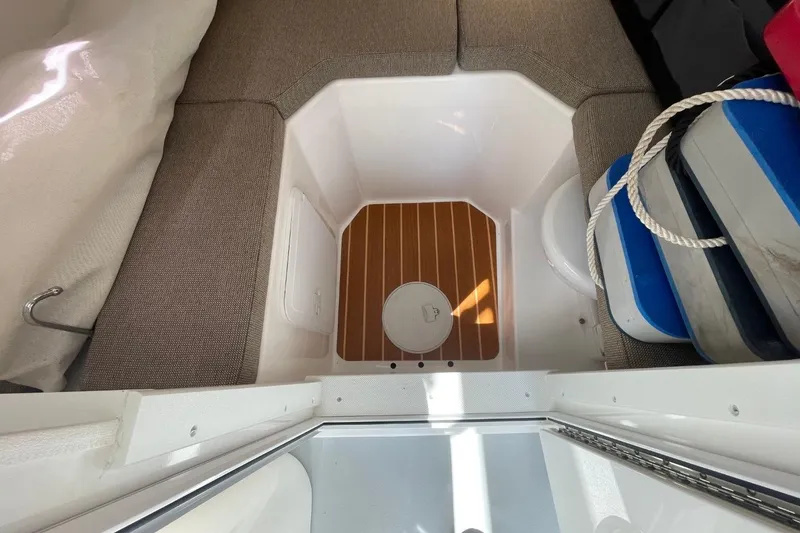 Slide: The Image of 2021 Steiger Craft 255 Chesapeake cabin interior with seating and storage area. - 32