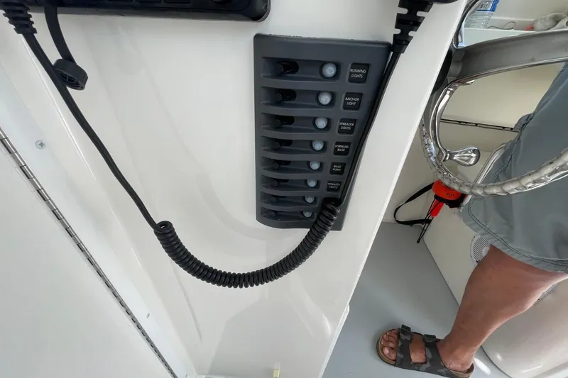 Slide: The Image of 2021 Steiger Craft 255 Chesapeake boat control panel with switches and coiled cord. - 37