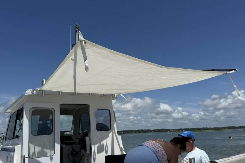 Slide: The Image of 2021 Steiger Craft 255 Chesapeake boat with sunshade, on a sunny day at sea. - 4