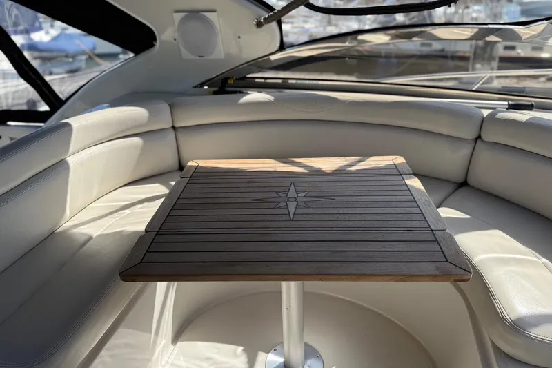 Slide: The Image of Luxurious interior of 2001 Regal Commodore 4160 yacht with elegant wooden table and cushioned seating. - 11
