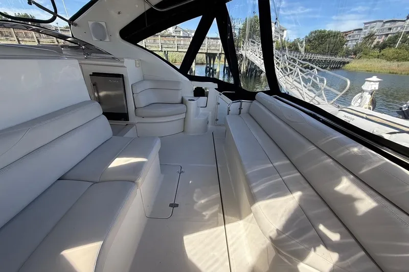 Slide: The Image of Luxurious interior of 2001 Regal Commodore 4160 yacht with white seating and scenic view. - 12