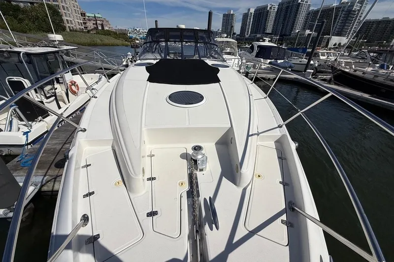 Slide: The Image of 2001 Regal Commodore 4160 yacht docked in marina, surrounded by modern buildings. - 2
