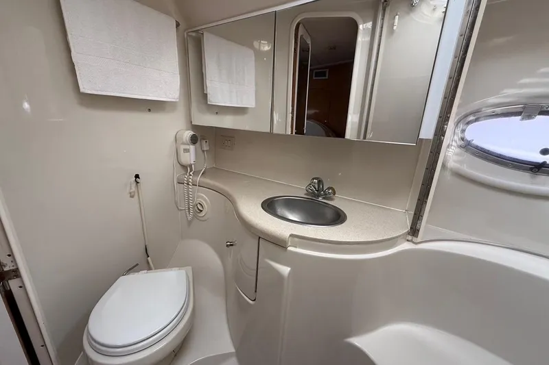 Slide: The Image of Bathroom interior of 2001 Regal Commodore 4160 yacht with sink, toilet, and mirror. - 21