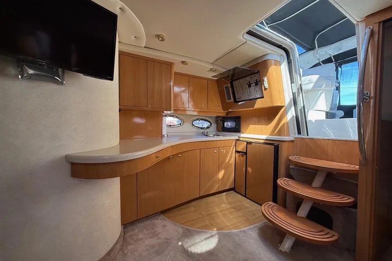Slide: The Image of Interior of 2001 Regal Commodore 4160 yacht with wooden cabinetry and modern amenities. - 23