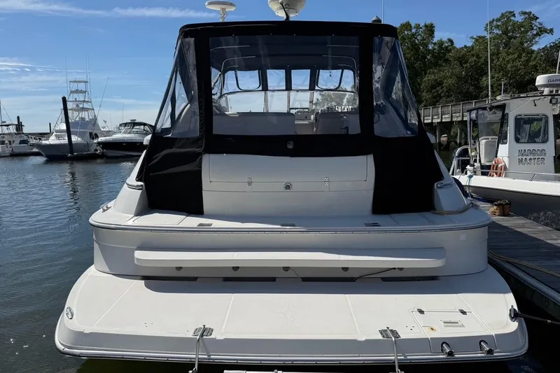 Slide: The Image of 2001 Regal Commodore 4160 yacht docked at marina, rear view with black canopy. - 25