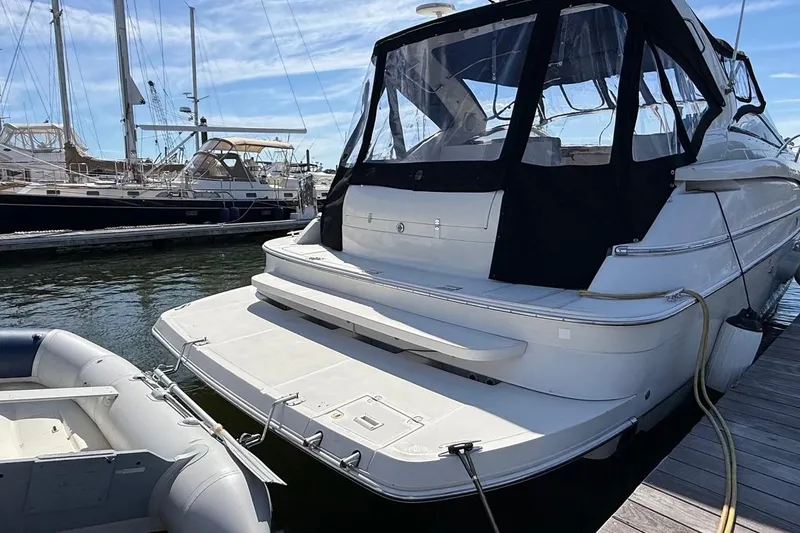 Slide: The Image of 2001 Regal Commodore 4160 yacht docked at marina with inflatable boat nearby. - 26