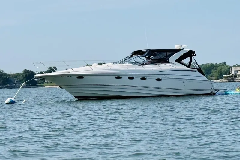 Slide: The Image of 2001 Regal Commodore 4160 yacht anchored on calm water, scenic background. - 3