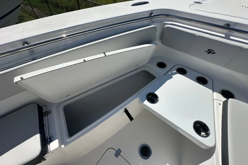 Slide: The Image of 2026 Sea Pro 262 Center Console boat interior with storage compartments and cup holders. - 7