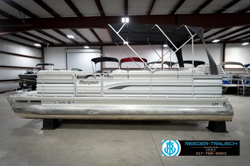 Slide: The Image of 1991 Godfrey Sanpan SP 2200 pontoon boat with Suzuki outboard motor in indoor storage. - 10