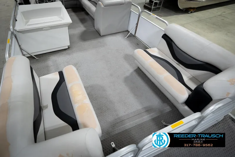 Slide: The Image of Interior of a 1991 Godfrey Sanpan SP 2200 pontoon boat with seating and storage. - 12