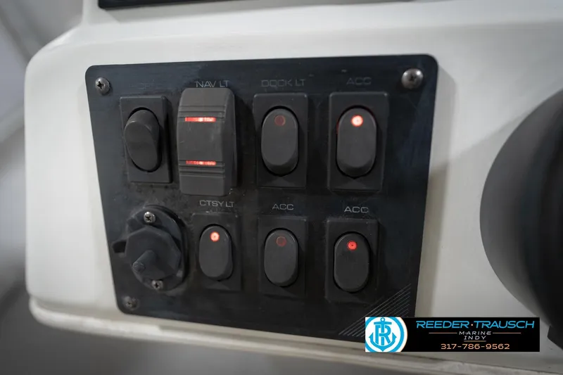 Slide: The Image of Close-up of a 1991 Godfrey Sanpan SP 2200 steering wheel in a marine setting. - 32