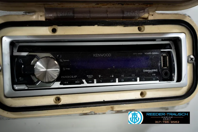 Slide: The Image of Control panel of a 1991 Godfrey Sanpan SP 2200 with Humminbird and Yamaha components. - 37