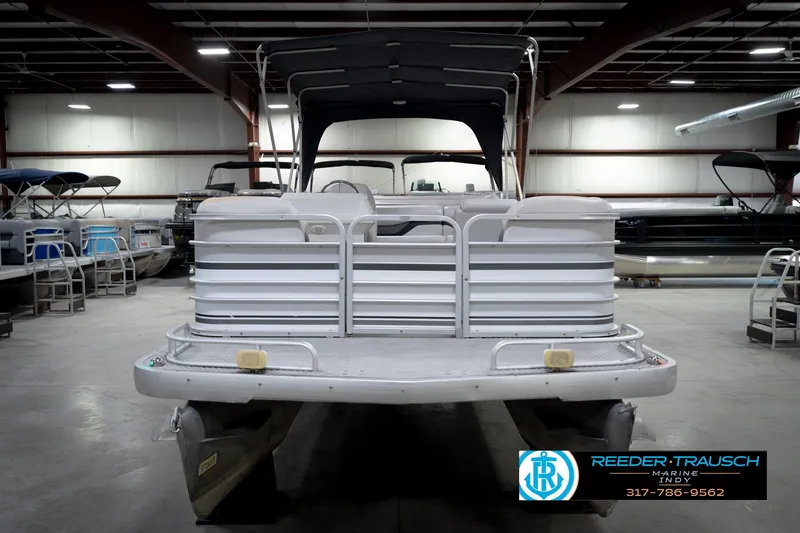 Slide: The Image of 1991 Godfrey Sanpan SP 2200 pontoon boat in indoor showroom. - 4