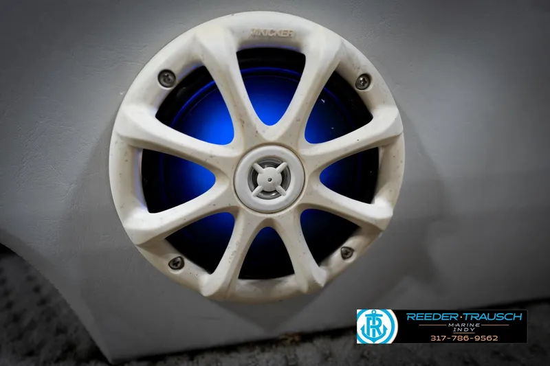 Slide: The Image of 1991 Godfrey Sanpan SP 2200 boat seat with white and gray upholstery in showroom. - 43