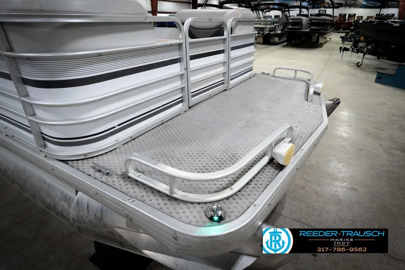 Slide: The Image of Outboard motor on a 1991 Godfrey Sanpan SP 2200 pontoon boat in a showroom. - 48