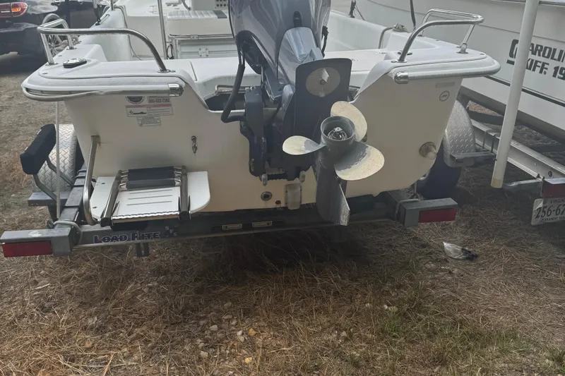 Slide: The Image of 2010 Carolina Skiff JVX16CC boat on trailer, rear view with outboard motor. - 3