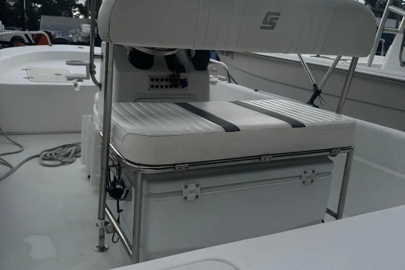 Slide: The Image of 2010 Carolina Skiff JVX16CC boat interior with cushioned seating and storage. - 4