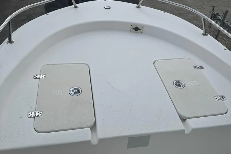 Slide: The Image of 2010 Carolina Skiff JVX16CC boat deck with storage compartments. - 5