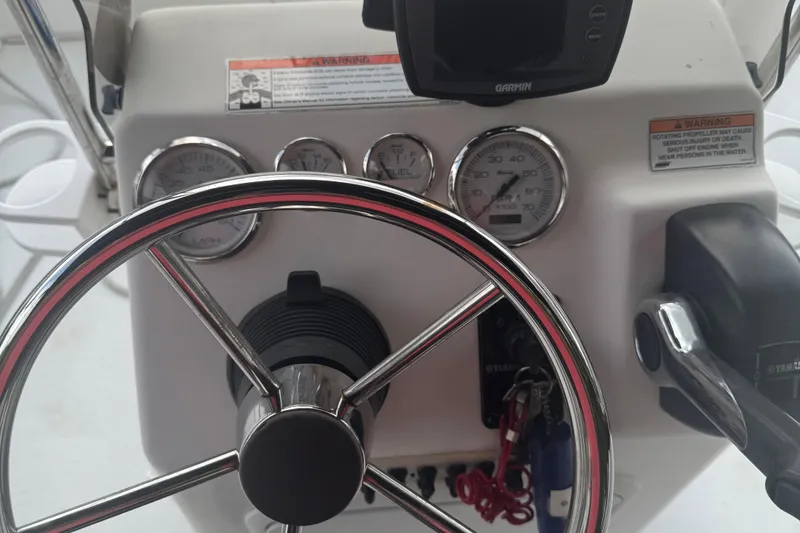 Slide: The Image of Steering console of a 2010 Carolina Skiff JVX16CC boat with gauges and controls. - 8