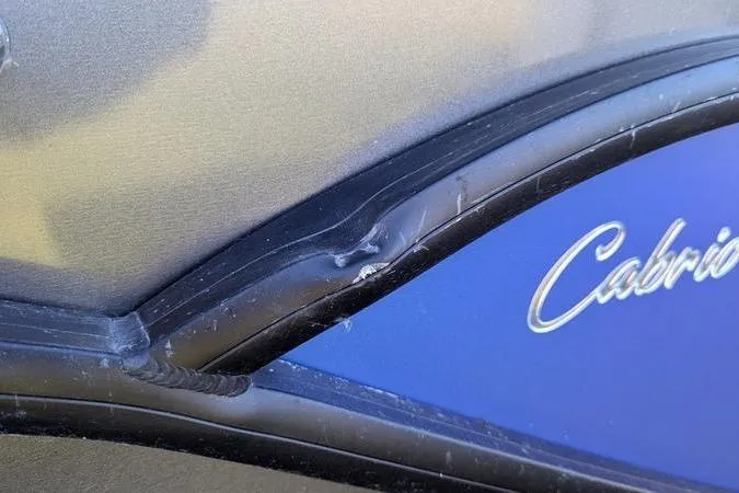 Slide: The Image of 2024 Barletta Cabrio 20UC with visible exterior damage near the logo. - 10