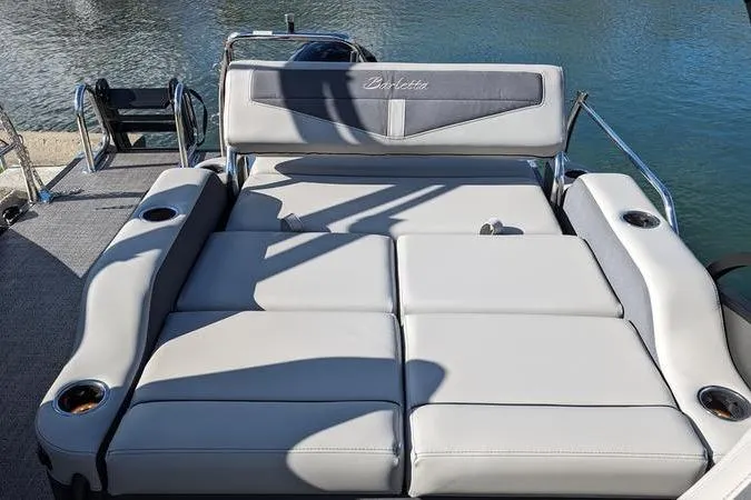 Slide: The Image of 2024 Barletta Cabrio 20UC boat with luxurious seating on a sunny day. - 6