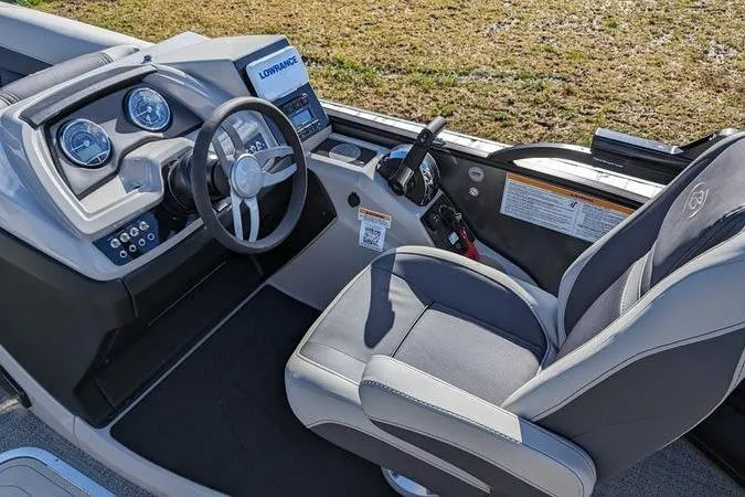 Slide: The Image of 2024 Barletta Cabrio 20UC boat cockpit with steering wheel and control panel. - 9