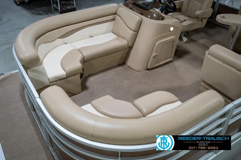 Slide: The Image of 2017 Bennington 18 SLX pontoon boat interior with beige seating and steering console. - 11