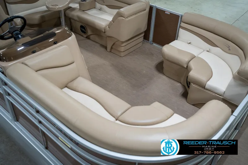 Slide: The Image of 2017 Bennington 18 SLX pontoon boat interior with beige seating and steering console. - 12