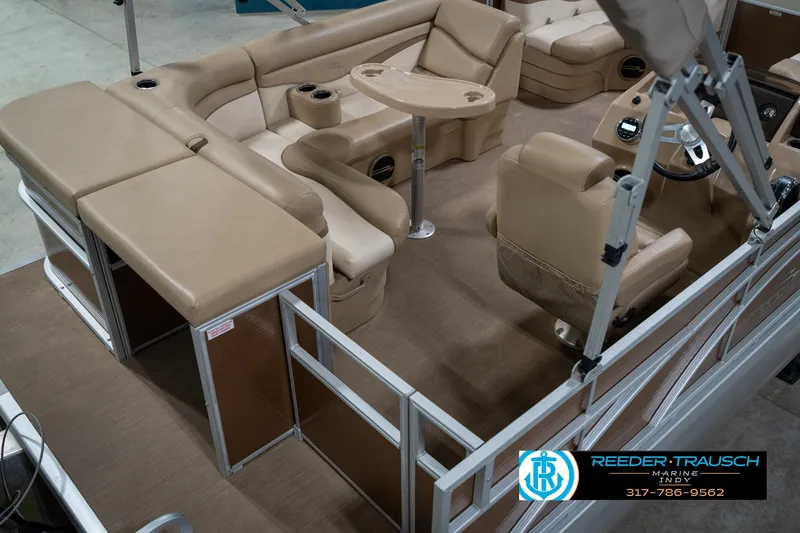 Slide: The Image of 2017 Bennington 18 SLX pontoon boat interior with beige seating and steering console. - 13