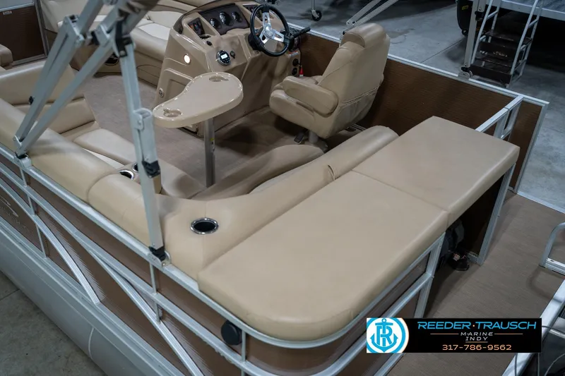 Slide: The Image of 2017 Bennington 18 SLX pontoon boat interior with beige seating and steering console. - 14