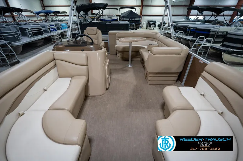 Slide: The Image of 2017 Bennington 18 SLX pontoon boat interior with beige seating and steering console. - 15
