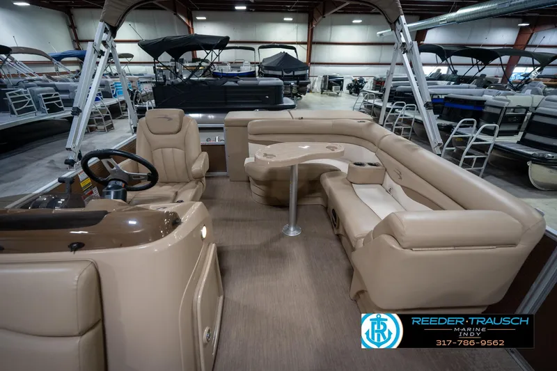 Slide: The Image of 2017 Bennington 18 SLX pontoon boat interior with beige seating and steering console. - 16