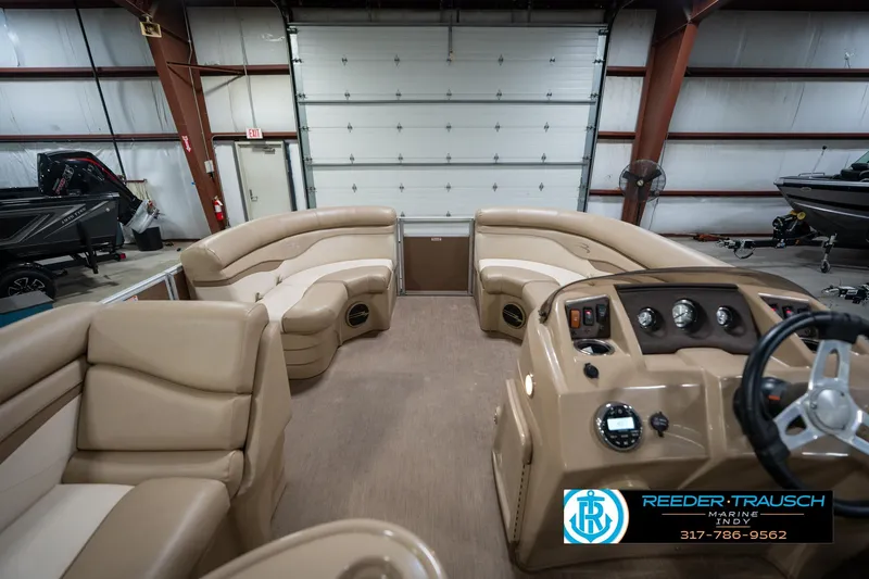 Slide: The Image of Interior of a 2017 Bennington 18 SLX pontoon boat with tan seating and control panel. - 19